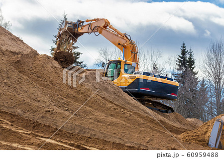 Yellow Excavator at Work in forest Yellow Excavator at Work in forest 60959488