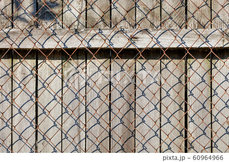 The weathered old gray wooden fence is closed  60964966