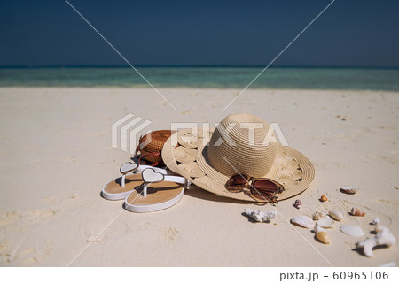 travel suitcase and accessories such as glasses, flip flops, lying on the beach, product photo for travel agencies and resorts, maldives travel suitcase and accessories such as glasses, flip flops, lying on the beach, product photo for travel agencies and resorts, maldives 60965106