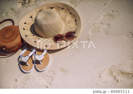travel suitcase and accessories such as glasses, flip flops, lying on the beach, product photo for travel agencies and resorts, maldives 60965111