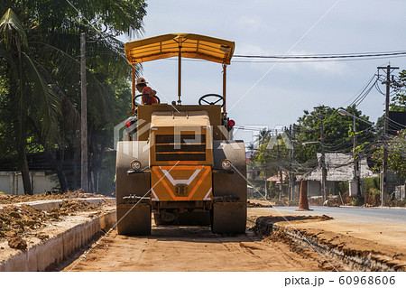 Road rollers working on the new roads construction site. Heavy duty machinery working on highway. Construction equipment. Compaction of the road. 60968606