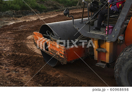 Road rollers working on the new roads construction site. Heavy duty machinery working on highway. Construction equipment. Compaction of the road. 60968698