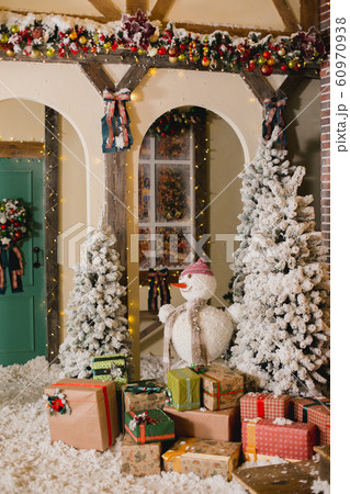 Close up a Christmas tree lights glittering at night. New Year fir tree with decorations and illumination. Xmas tree decorations background. Many large golden balls on fir tree New Year and Christmas 60970938