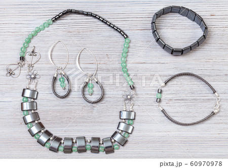 handmade necklace, earrings and bracelets on gray 60970978