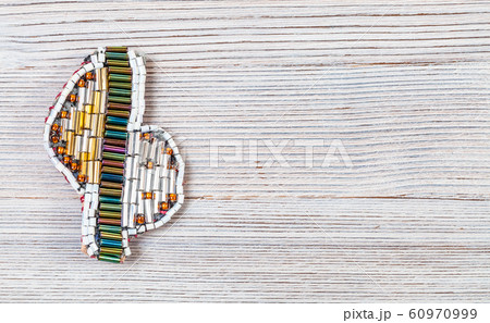 brooch from various glass bugles and beads on gray brooch from various glass bugles and beads on gray 60970999