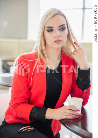 Nice young blonde posing in a cafe 60973055