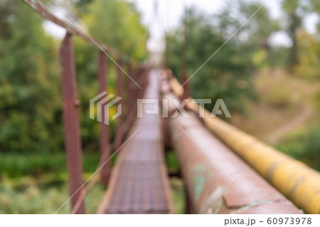 A narrow old rusty river crossing, along with a A narrow old rusty river crossing, along with a 60973978