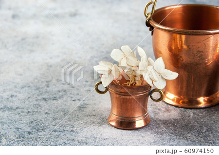 Set of 3 copper miniatures on concrete background 60974150
