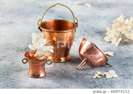 Set of 3 copper miniatures on concrete background 60974152