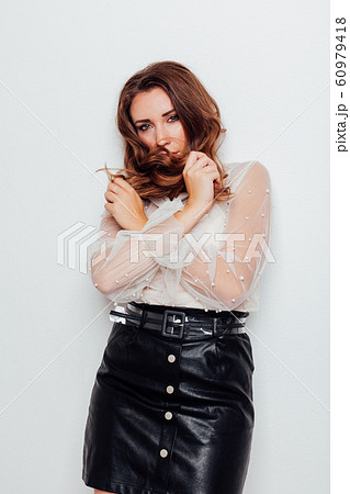 portrait of a beautiful fashionable woman with hair curls in business clothes at work in the office portrait of a beautiful fashionable woman with hair curls in business clothes at work in the office 60979418