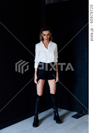 Portrait of a beautiful fashionable blonde woman in black white style dress Portrait of a beautiful fashionable blonde woman in black white style dress 60979720