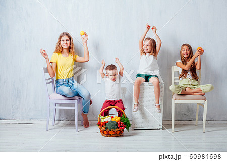 four children with fresh vegetables healthy food 60984698