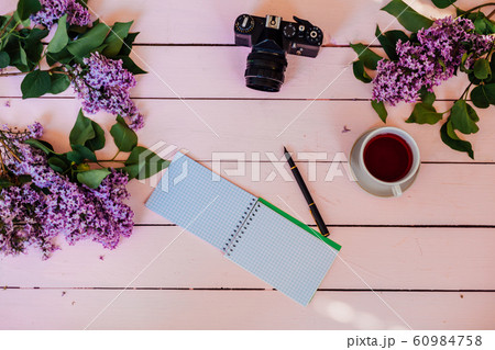 on the white table lilac, gift, notebook, cup of tea 60984758