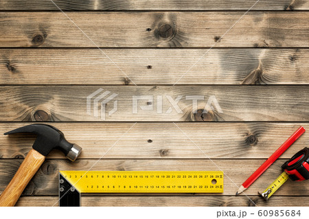 Work tools for carpenter on wooden background. 60985684