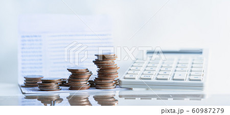 Bank passbook with calculator and stack money coin for growing business.  60987279