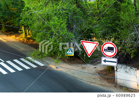 Traffic signs on a wire over the road. A sign Traffic signs on a wire over the road. A sign 60989625