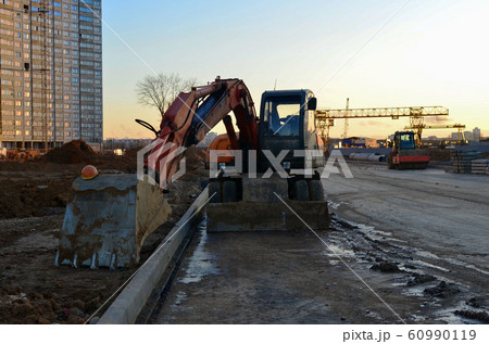 Tracked excavator working at a construction site Tracked excavator working at a construction site 60990119