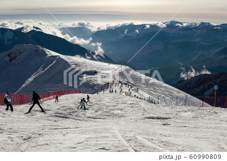 skiing, snowboarding and downhill skiing in the winter resort 60990809