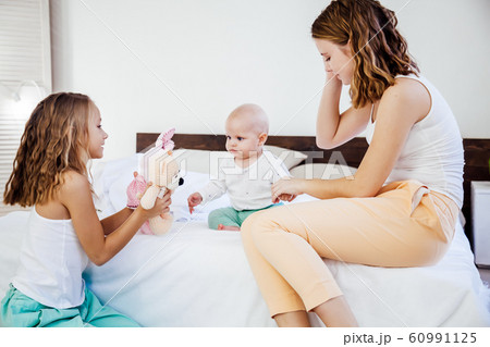 three girls sisters in the play in the bedroom in the morning love 60991125