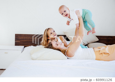 three girls sisters in the play in the bedroom in the morning love 60991126