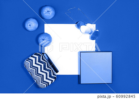 Female fashion layout with white paper sheet, orange tangerines and female accessories on classic 60992845