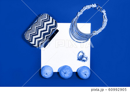Female fashion layout with white paper sheet, orange tangerines and female accessories on classic 60992905