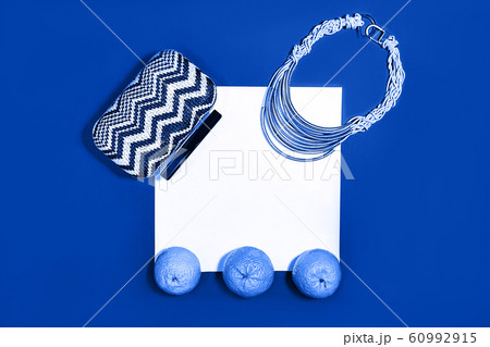 Female fashion layout with white paper sheet, orange tangerines and female accessories on classic 60992915