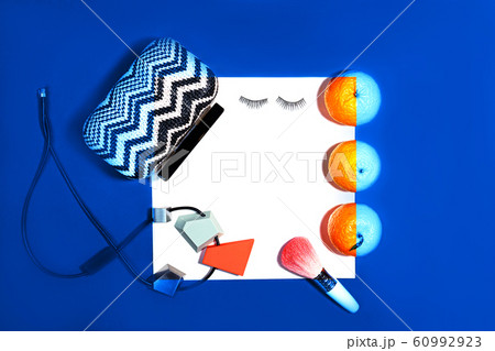 Female fashion layout with white paper sheet, orange tangerines and female accessories on classic 60992923