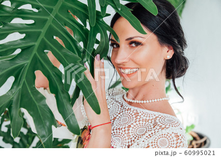 Portrait of a beautiful fashionable brunette woman in a dress with the colors of the house 60995021