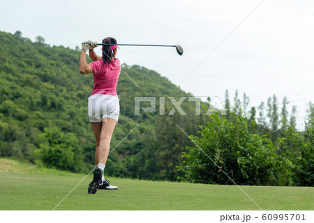 Professional golfer asian woman approach on tee off for swing and hitting golf 60995701