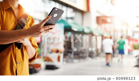 Traveling backpacker take a photo in street and outdoor market in summer. 60996323
