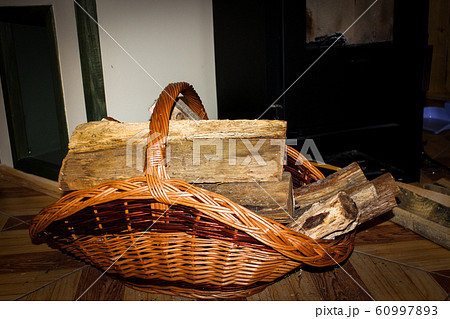 Wooden logs that stand near the fireplace in a Wooden logs that stand near the fireplace in a 60997893