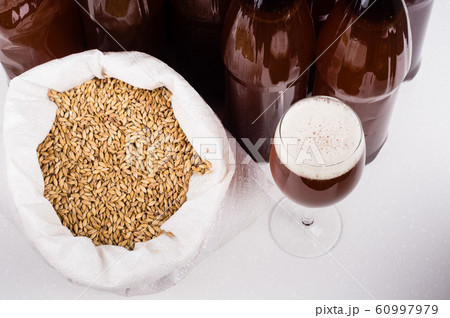 glass of home made craft beer and a bag of light glass of home made craft beer and a bag of light 60997979