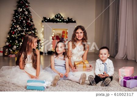 the little boy and three girls open Gifts Christmas new year tree Garland 61002317