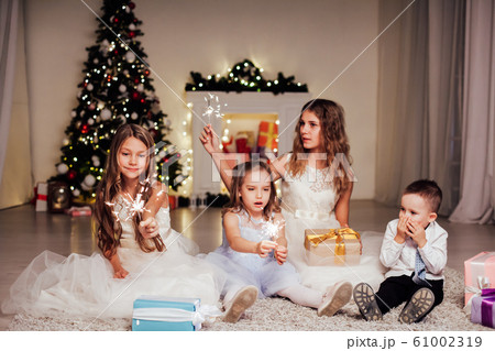 Kids open Christmas sparklers gift new year holiday lights Christmas tree garlands 61002319