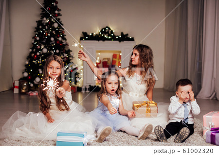 the little boy and three girls open Gifts Christmas new year tree Garland 61002320