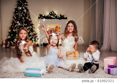 the little boy and three girls open Gifts Christmas new year tree Garland 61002321
