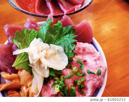 Lunch of raw fish meal on rice in restaurant. Lunch of raw fish meal on rice in restaurant. 61003252