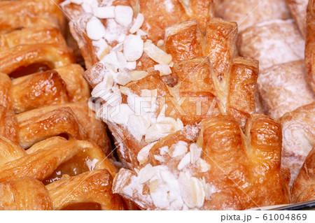 Buns with almond petals and sugar powder Buns with almond petals and sugar powder 61004869