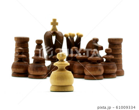 Underdog Concept: One White Pawn Standing Against Black Chess Pieces 61009334