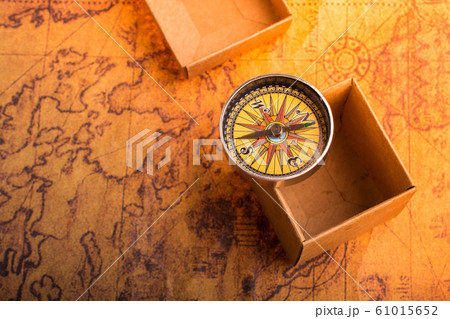 Compass beside a box on a map as concept of 61015652