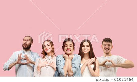 Portrait of multiethnic group of young people isolated on pink studio background, flyer, collage 61021464