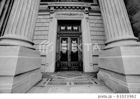 Massive ancient roman columns with wooden door Massive ancient roman columns with wooden door 61023962
