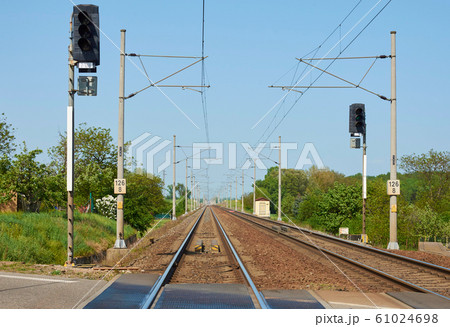 Train tracks with columns, electric wires and Train tracks with columns, electric wires and 61024698