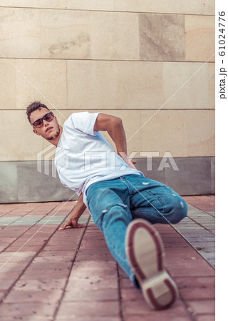 Man dancer dancing breakdance, summer in city, hip hop break dancer pose. Youth lifestyle, active, trend modern, fitness sport, positive motivation. 61024776