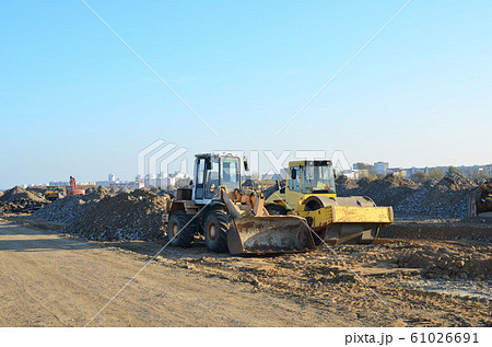 Soil Compactor and wheel loader at construction site.  61026691