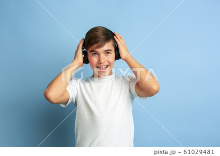 Caucasian teen's portrait isolated on blue studio background 61029481