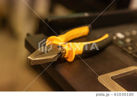 work tool yellow black cutting pliers close-up on 61030180