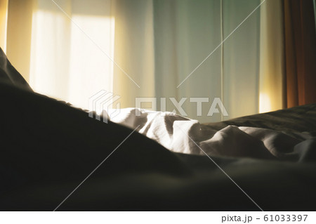 Abstract background. Closeup blanket sheet on bed with sunlight on window. Abstract background. Closeup blanket sheet on bed with sunlight on window. 61033397