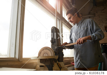 Carpenter cutting the wood on lathe Carpenter cutting the wood on lathe 61036178